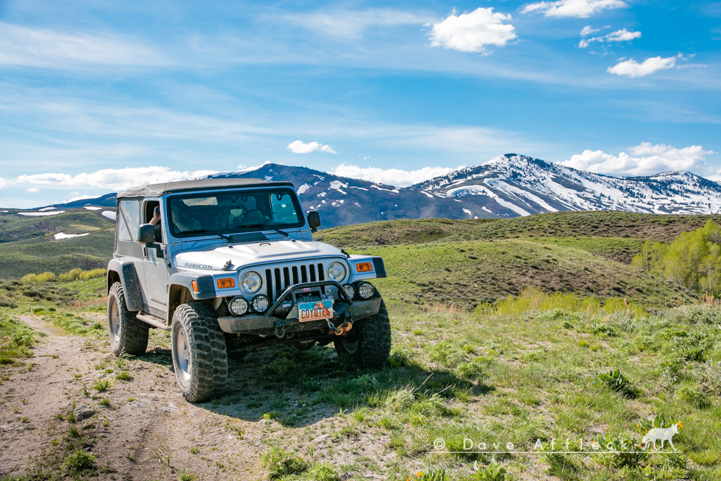 Jeep with snow capped peaks in background