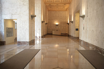 INT/EXT. LOBBY - CARLISLE'S BUILDING