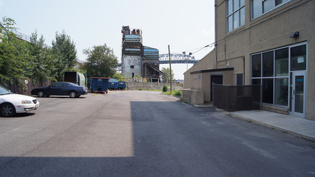 EXT. INDUSTRIAL AREA NEAR RIVER